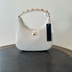 BCBG, medium size handbag, cream color w/gold studs. Comes w/shoulder strap.